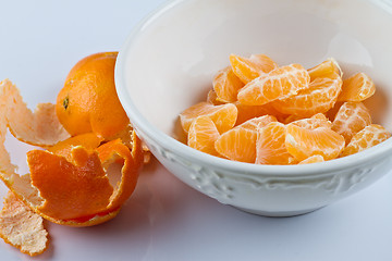 Image showing Peeled clementines in bowl