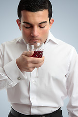 Image showing Man smelling red wine