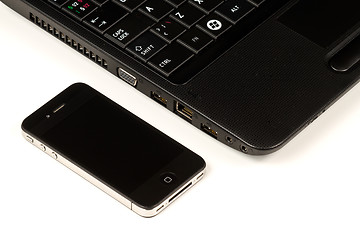 Image showing Smartphone and laptop on white background