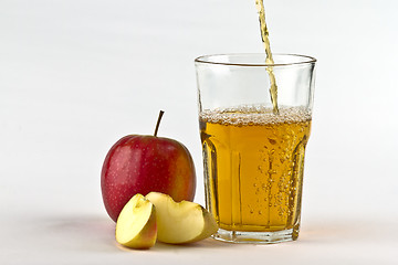 Image showing Apple cider pouring down into glass