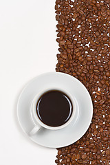 Image showing Coffee in white cup on saucer placed cofee beans 