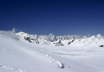 Image showing Ski slope against mountain peaks