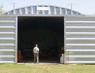 Image showing man and metal building