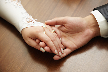 Image showing Hands of newly-married couple