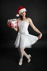 Image showing Girl in Christmas hat with gifts