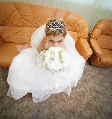 Image showing Bride sits on leathern sofa