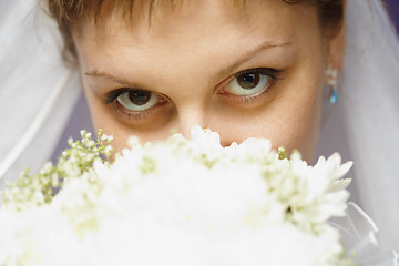 Image showing Eyes of bride and bridal bouquet
