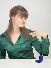 Image showing Young woman admires new jewel