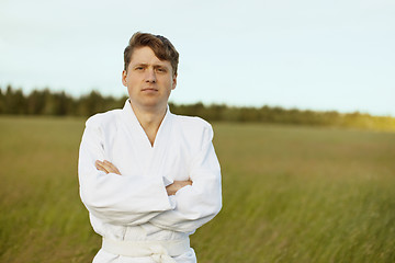 Image showing Man in white kimono against evening nature