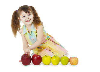 Image showing Little girl playing with fruits
