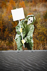 Image showing Scientist in gas mask with poster