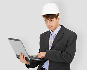 Image showing Construction superintendent with computer in hands on grey backg