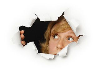 Image showing Woman looks out of hole with curiosity