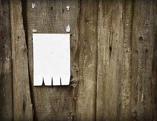 Image showing Paper advertisement on wooden fence