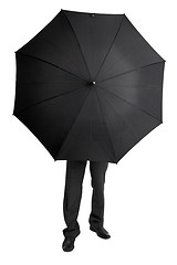 Image showing Man hid behind large black umbrella