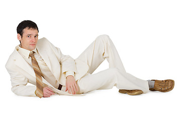 Image showing Handsome young man in suit lying on white