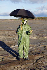 Image showing Person with umbrella waits radioactive rain