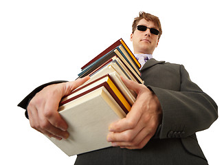 Image showing Blind man holding stack of books