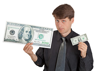 Image showing Young man holding large and small money