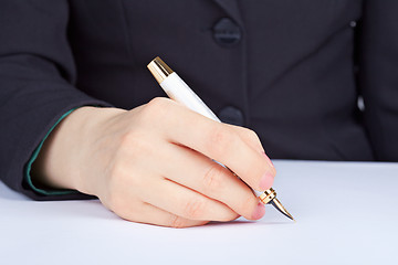 Image showing Person undersigns an golden pen