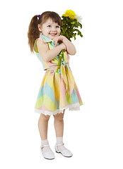 Image showing Happy little girl holds bouquet of flowers
