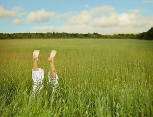 Image showing Bare feet from green grass