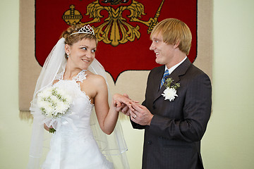 Image showing Bride and groom on background of coat of arms