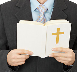 Image showing Man reads Catholic Bible