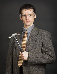 Image showing Man in goggles keeps in readiness a hammer