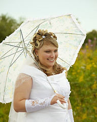 Image showing Happy bride with a parasol