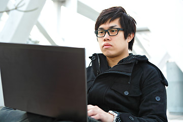 Image showing Man using computer outdoors