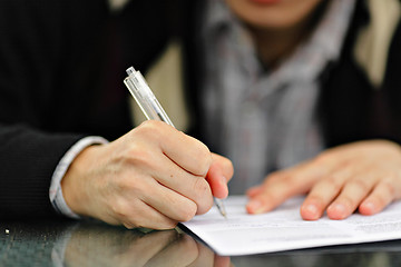 Image showing Hand with Pen Signing Form