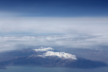 Image showing Snow-covered mountains and clouds