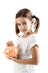 Image showing Little girl with a piggy-bank