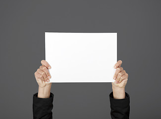 Image showing Holding a paper card