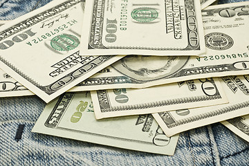 Image showing US dollar banknotes and jeans