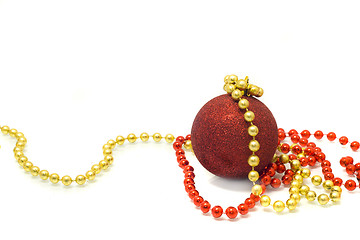 Image showing Christmas is coming. Red Decoration ball, red and golden tinsel 