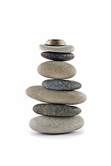 Image showing Welfare and Stability  - Balanced stone stack with coins
