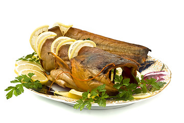 Image showing Tasty bloated sheatfish with lemon and parsley