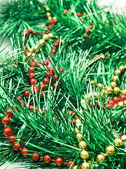 Image showing Christmas comes - green tinsel and beads