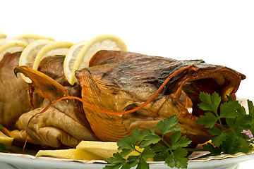 Image showing Shore dinner - tasty smoke-dried sheatfish with lemon and parsle