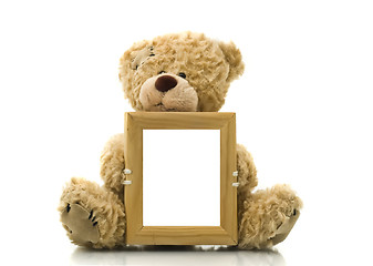 Image showing Cute bear holding empty frame for picture or photo