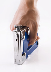 Image showing Staple gun in man's arm over white