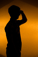 Image showing Looking forward. Back lit silhouette of confident man