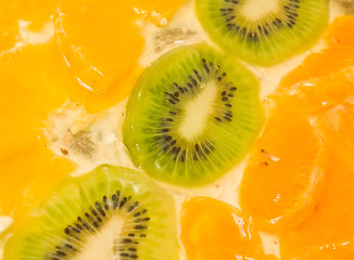 Image showing Fruit background. Sliced kiwi, orange, mandarin