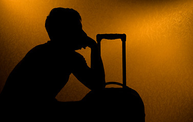 Image showing Traveling - silhouette of man and suitcase