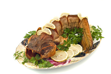 Image showing Bloated fresh-water catfish (sheatfish) with lemon