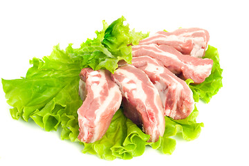 Image showing Pork meat pieces on green salad Isolated