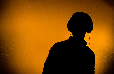 Image showing DJ with earphones 