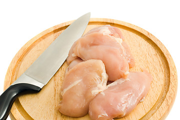 Image showing Chicken fillet and knife on hardboard isolated